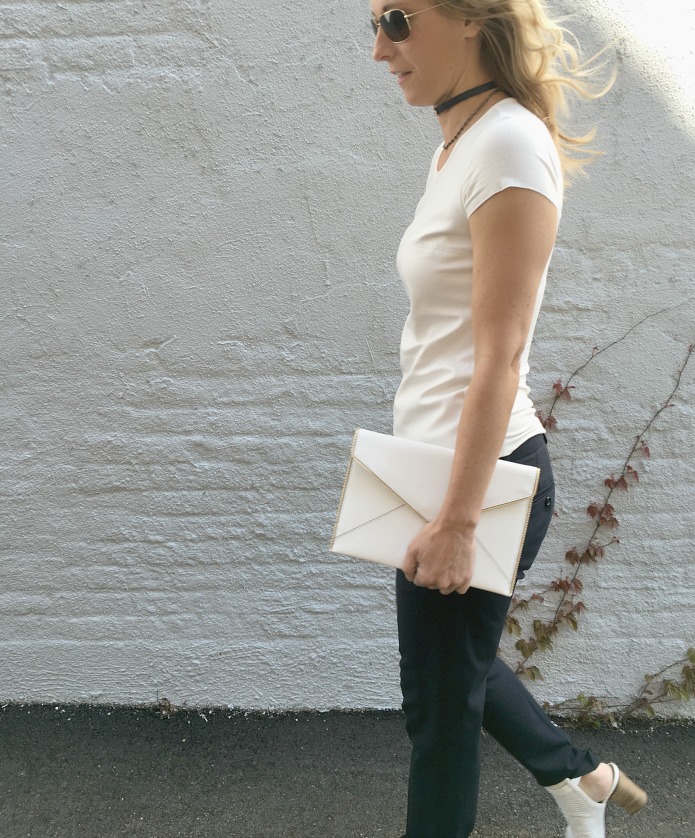 woman wearing white top, black jeans, and Choker Trend