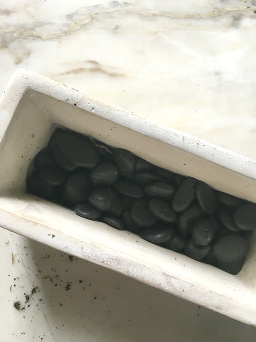 stones in a white rectangular pot