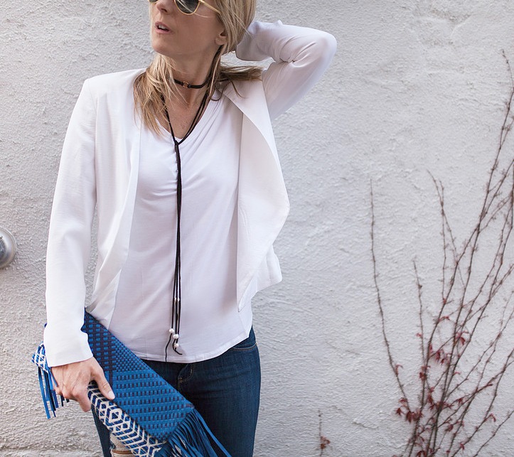 woman wearing white top and blazer, jeans, and Choker Trend