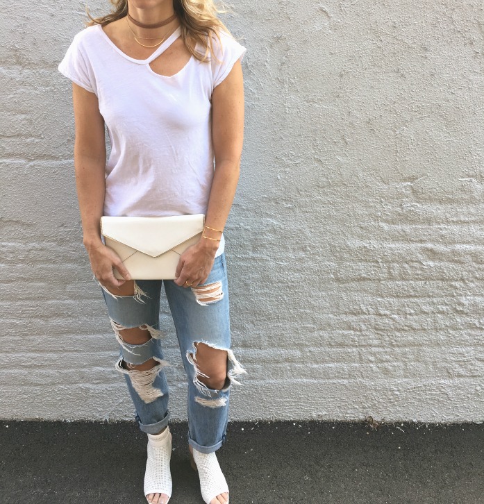 woman wearing white shirt and tattered jeans