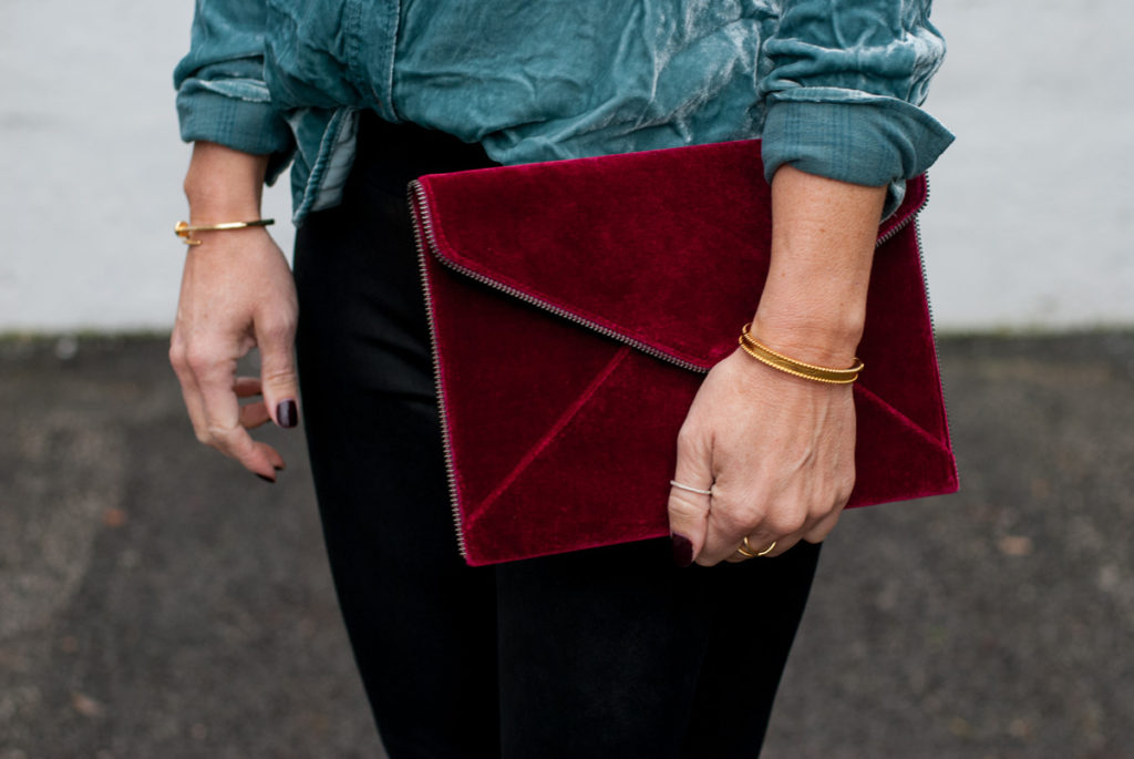 woman holding a red velvet pouch from Black Friday sales