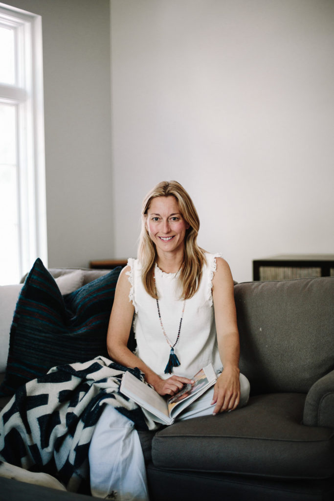 woman sitting on a couch with Alpaca Throw 