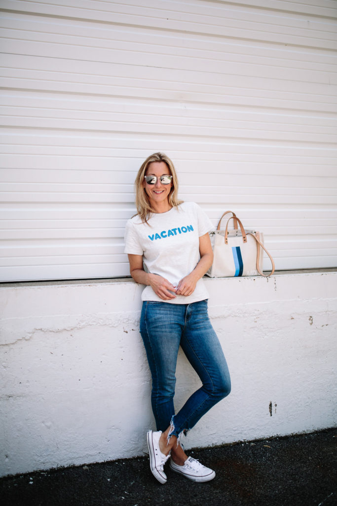 woman spending Summer in Chicago and leaning on a wall