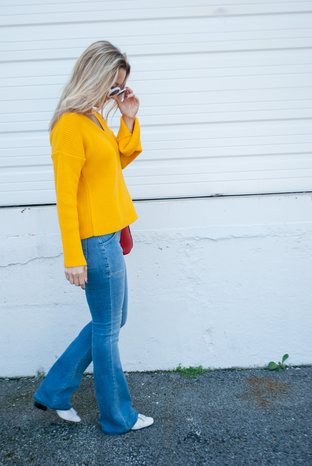 a girl in a marigold fall color sweater