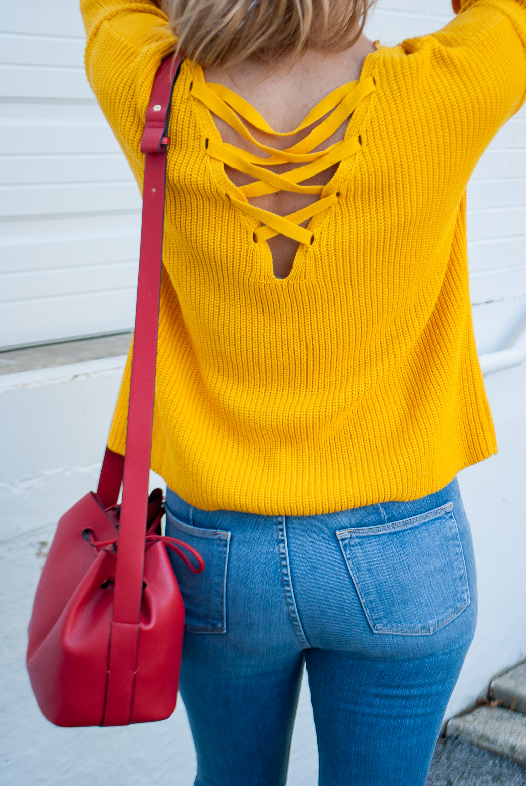 jeans and a sweater and purse