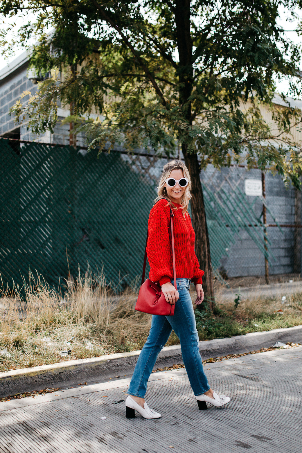 a red sweater with a high neck and sunglasses