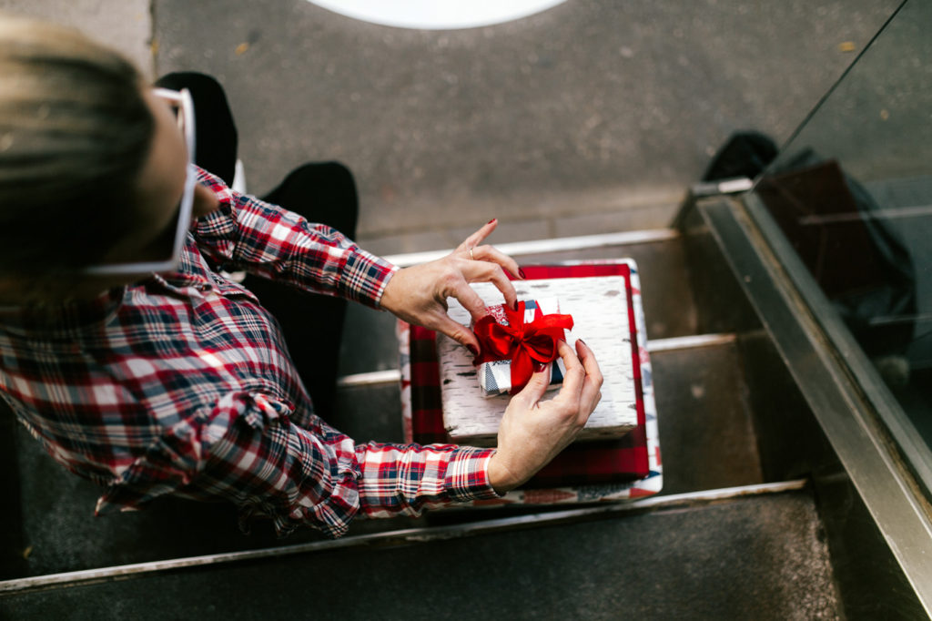 woman sharing a collection of hostess gifts under $50 for the holidays