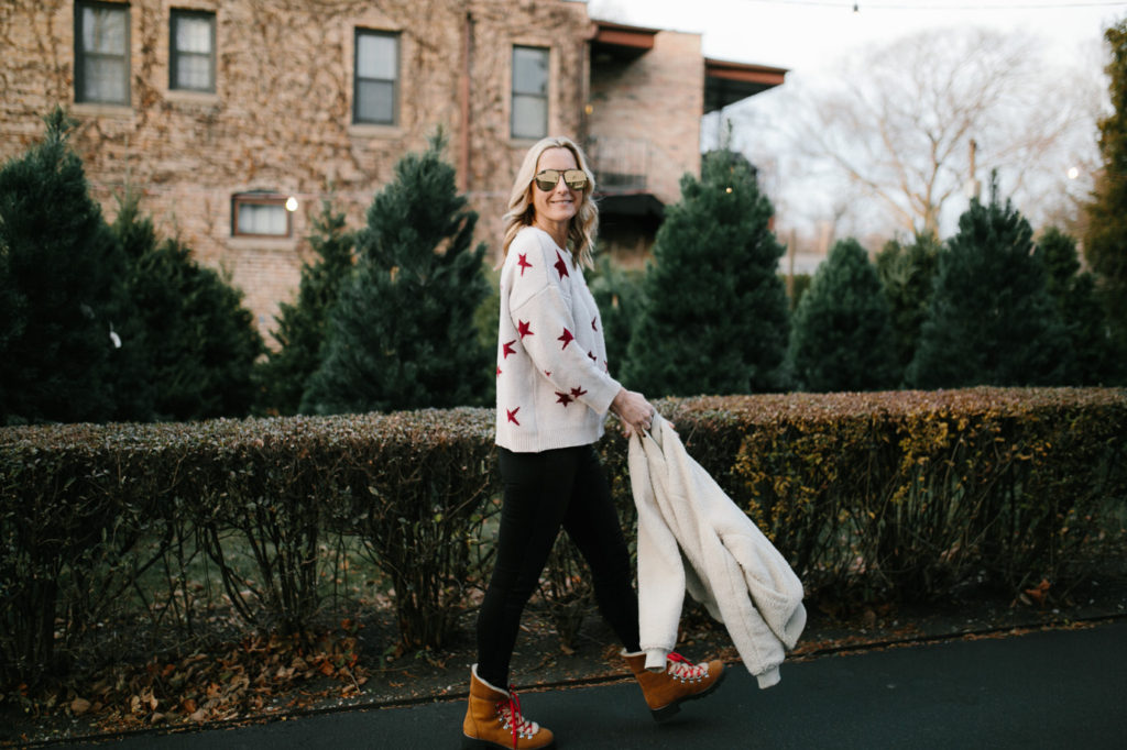 woman in jeans and sweater sharing holiday season with teenagers