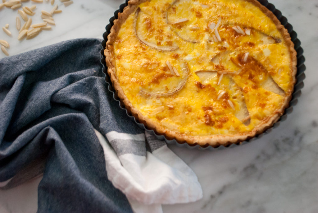 Quiche with sliced pear, slivered almonds and Swiss cheese