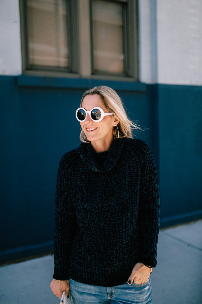 25 Intentions New Year and wearing aNavy chenille sweater paired with loose denim and white booties