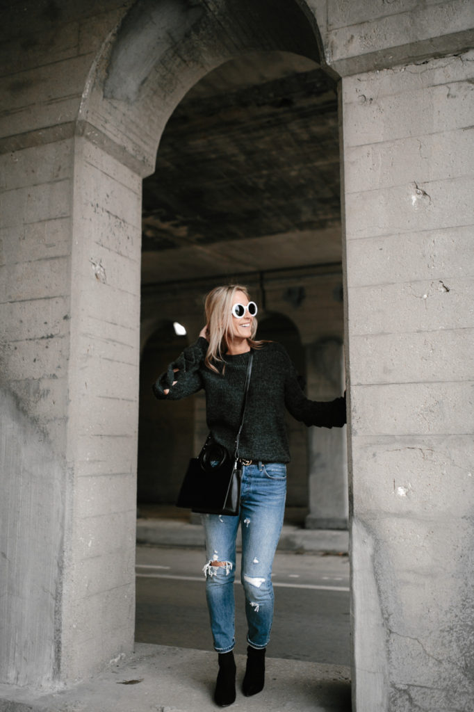 woman wearing go sweater night and jeans 