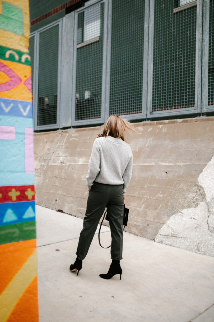 woman turning her back wearing sweatshirt and paper-bag pant