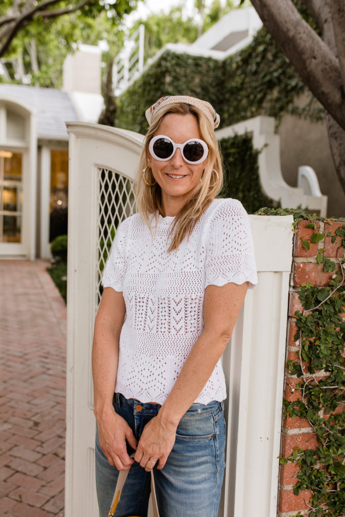 woman wearing white top eyelet clothing for spring