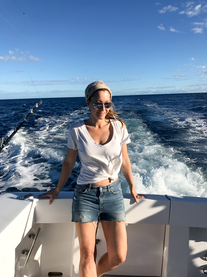 woman wearing White Tee, Denim Shorts, Ray-Bans, Bandana in Hair