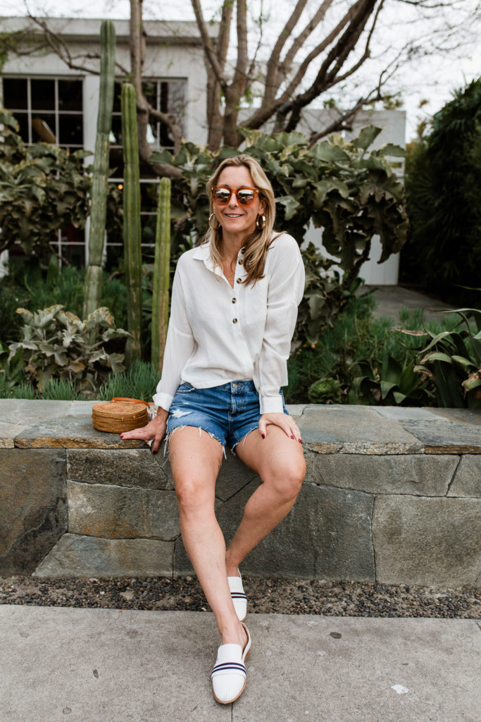 woman wearing denim shorts and White Essentials for Spring 
