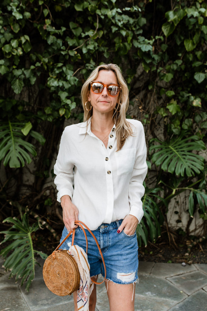 woman hands in pockets and wearing denim shorts and White Essentials for Spring 