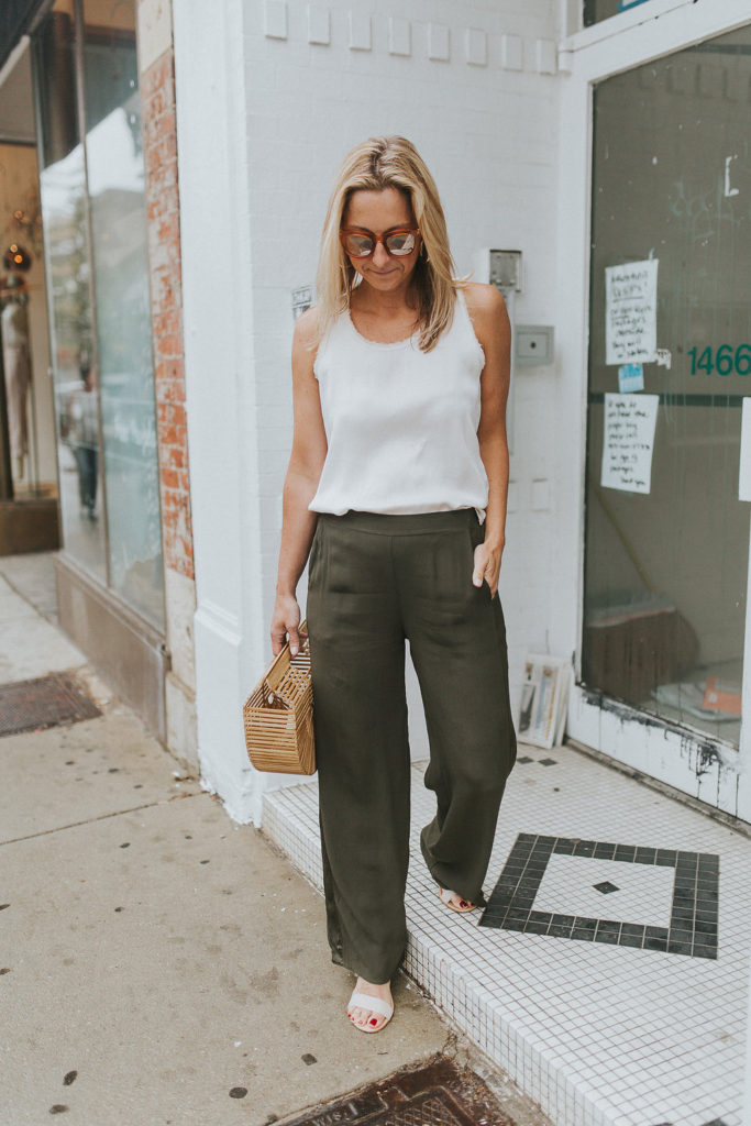 Megan is holding a Cult Gaia bag - Never Without Navy